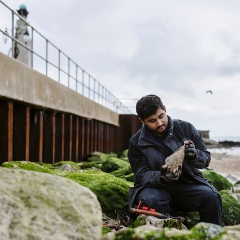 Palaeontology students Hamzah Imran on Southsea beach by the old seawall