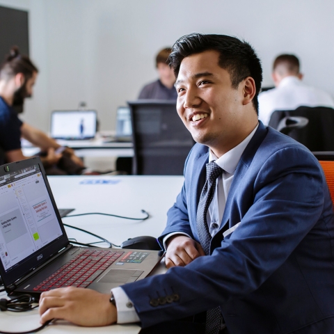 Male student working with laptop at University of Portsmouth