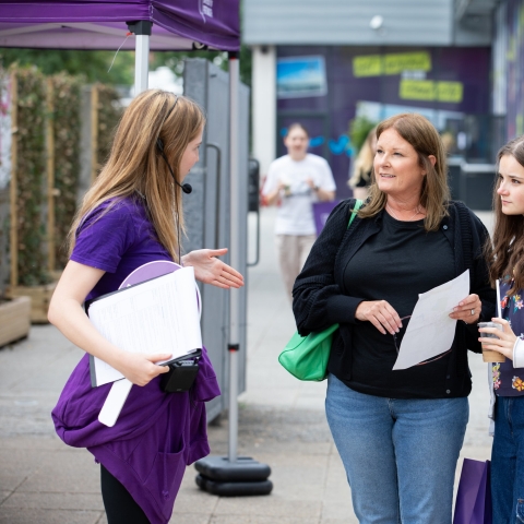 Student ambassador helping family with questions - Open Day 2023