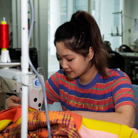 Venus Haochun Chen using sewing machine
