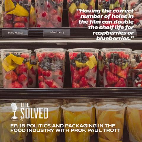 Plastic packaged fruit in yellow and red on shop shelves