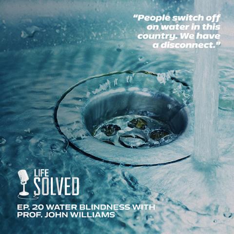 Close up of sink plughole with running water. Life Solved logo in corner
