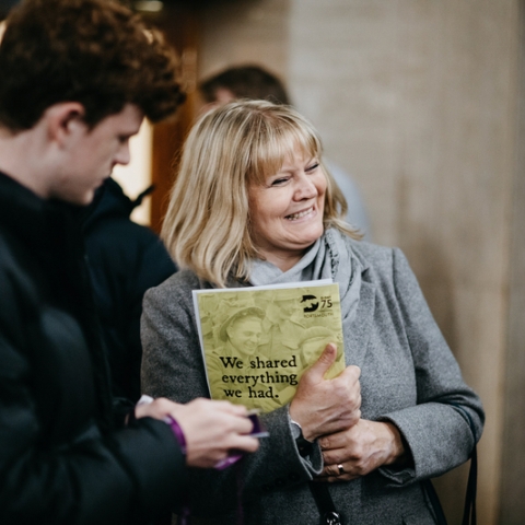 Parent and young person attending an event smiling