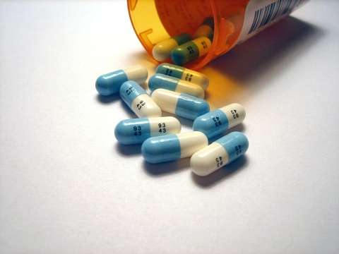 Close up of prozac pills spilling out of bottle