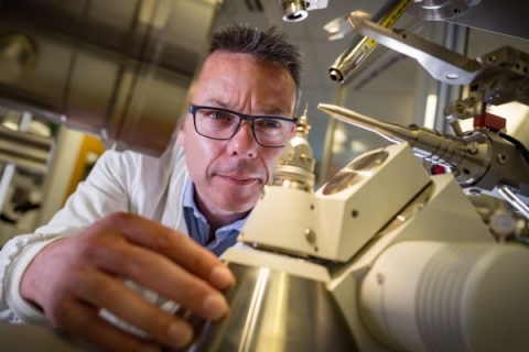 scientist inspecting scientific equipment