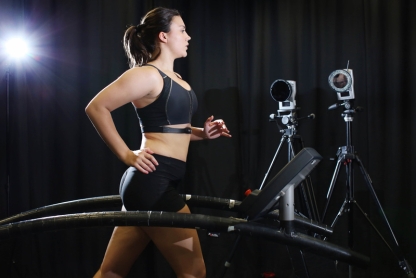 Female runner on treadmill with motion capture cameras