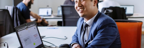 Male student working with laptop at University of Portsmouth