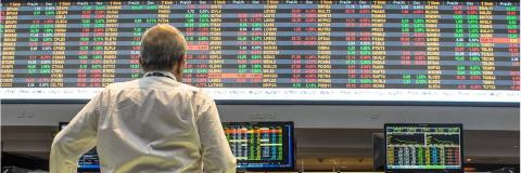 Student examining stock exchange screen