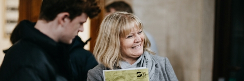 Parent and young person attending an event smiling