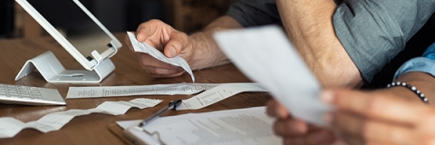 Close up of hands holding receipts