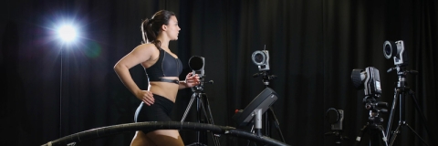 Female runner on treadmill with motion capture cameras