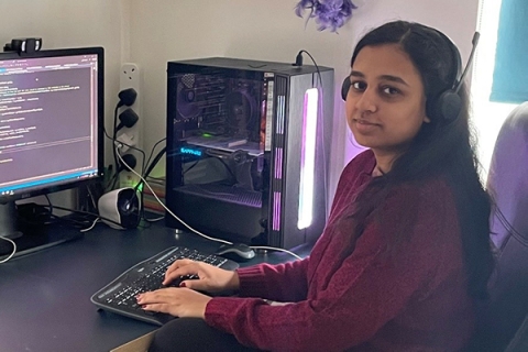 student at a computer using business analytics software