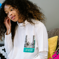Female student sat on her bed listening to music 
