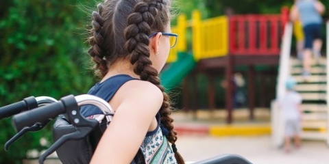 A young female wheelchair user in a park
