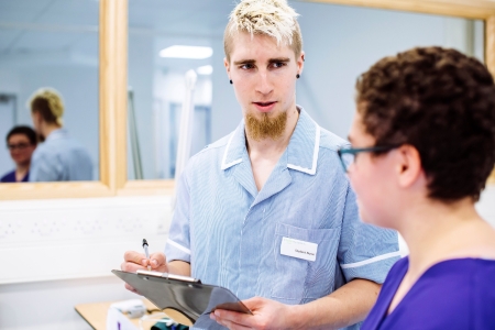 Nursing student writing down medical record
